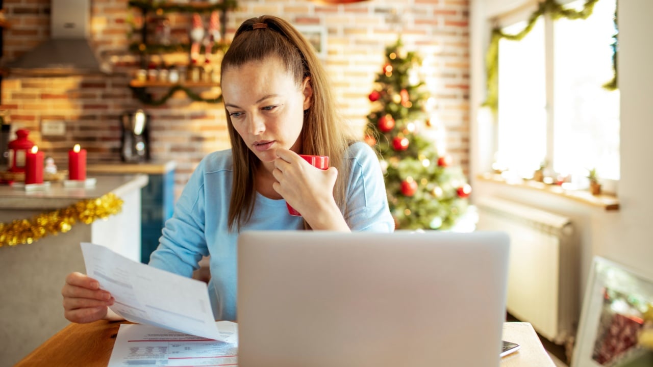 Young woman doing financials during the Christmas holidays at home