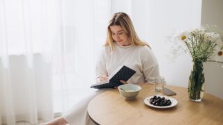 Young beautiful female student at home doing creative journal.