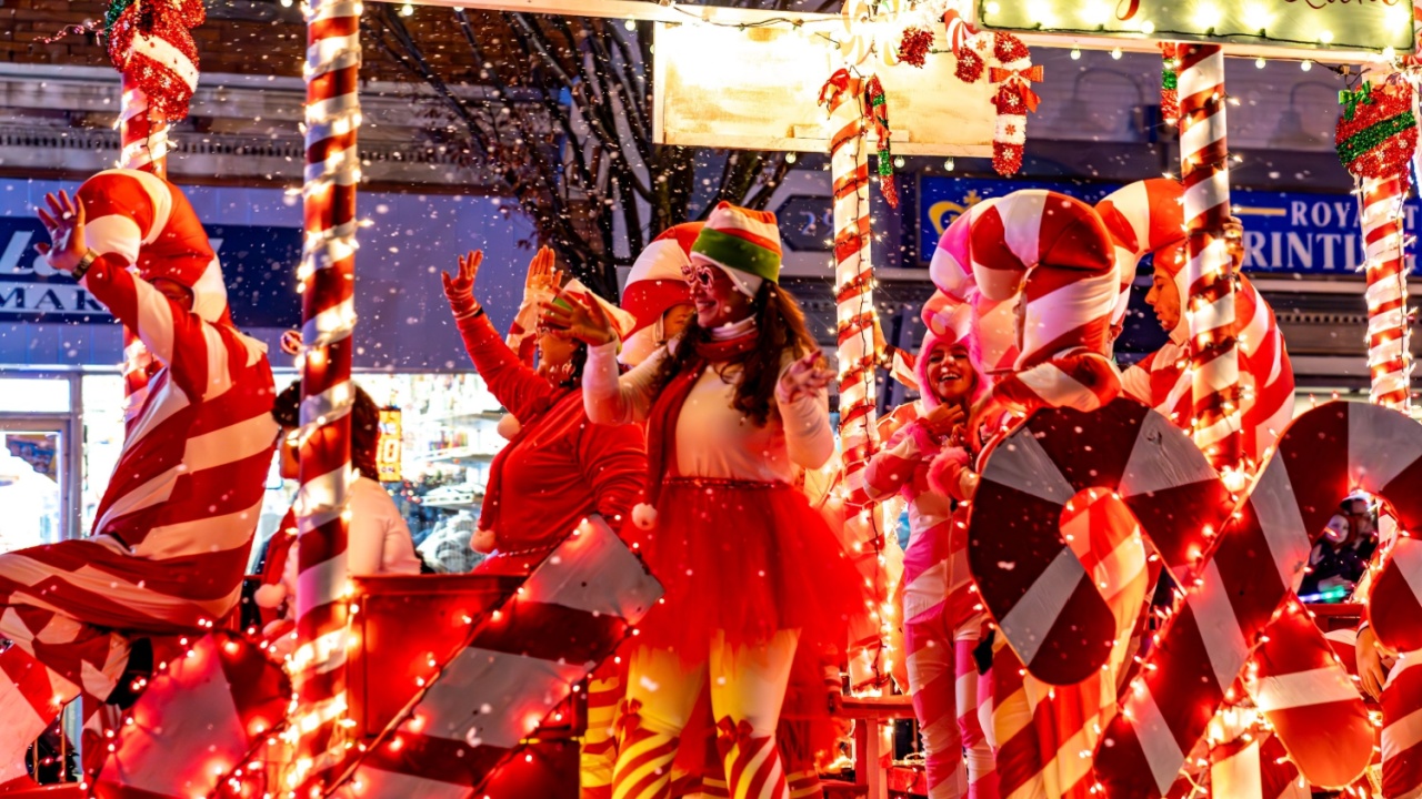 Suffern, NY - US - Dec 2, 2023 Horizontal view of an illuminated red and white decorated Candy Cane Lane float in the Suffern Annual Holiday Parade on Lafayette Avenue in downtown Suffern.