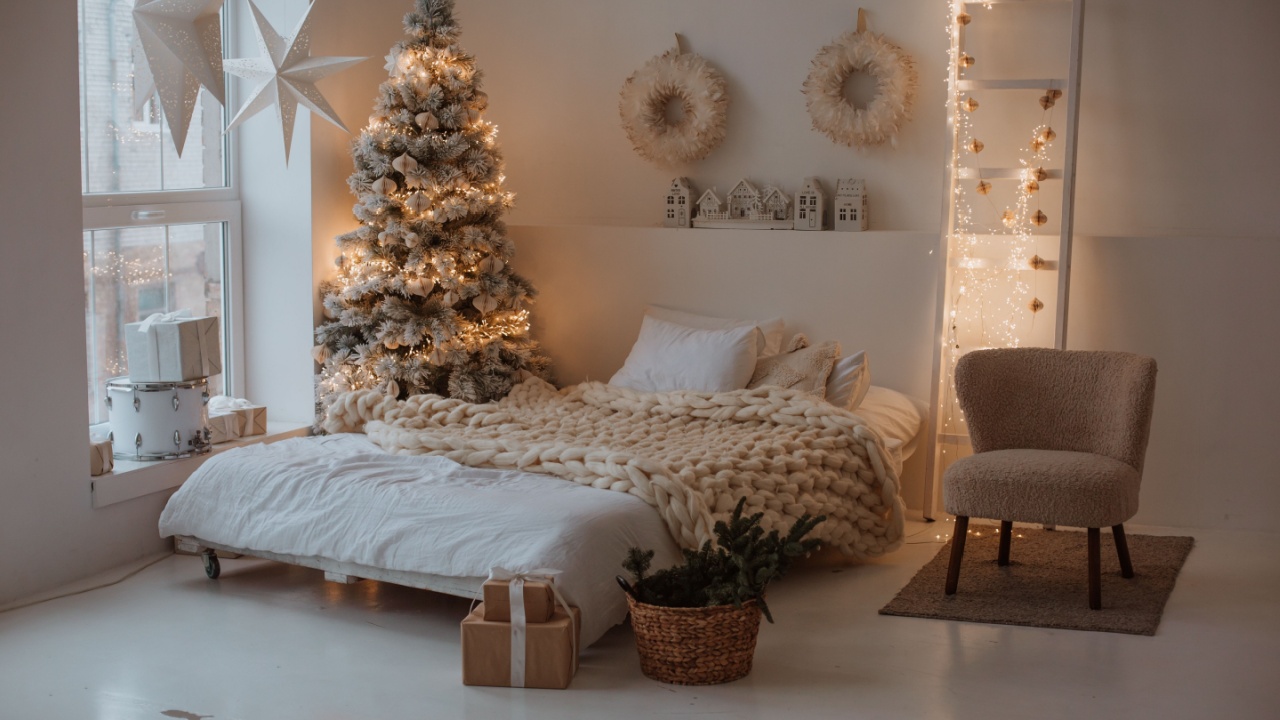 spacious bright bed room prepared for Christmas. luxury bedroom with shiny Christmas tree. garlands, presents, Christmas Eve