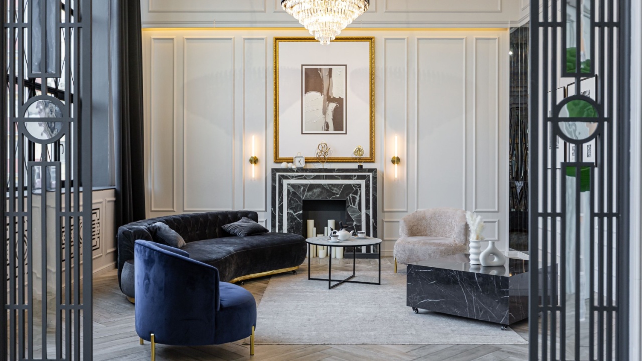 stylish cozy light bright luxurious spacious interior of a country house white walls with ornaments, fireplace, work area and recreation area without people during the day