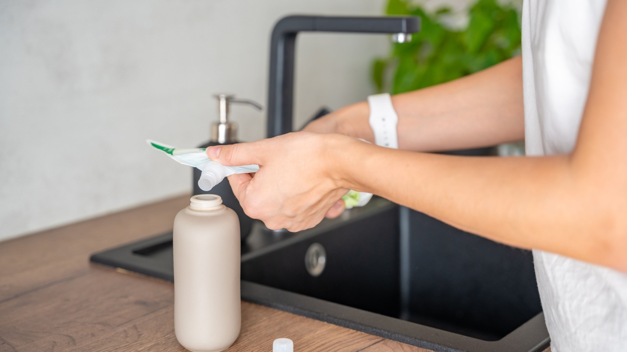 A woman pours soap or detergent from recycled packaging into a reusable bottle. Eco-friendly lifestyle concept. High quality photo