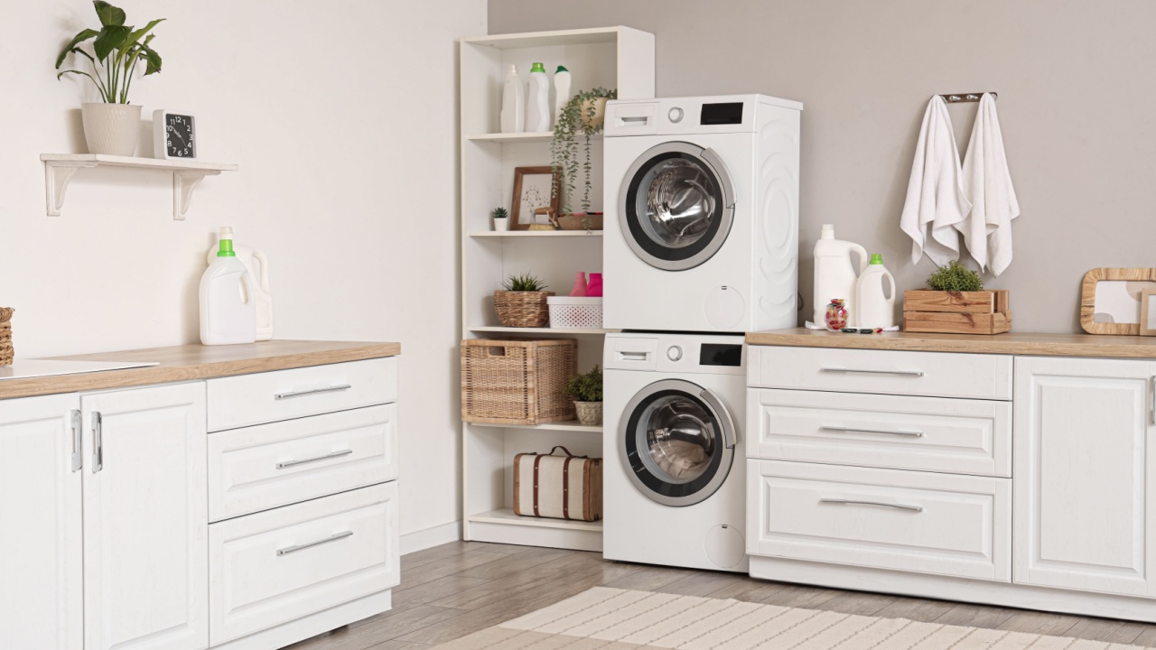 Interior of modern laundry room with washing machines and cleaning supplies