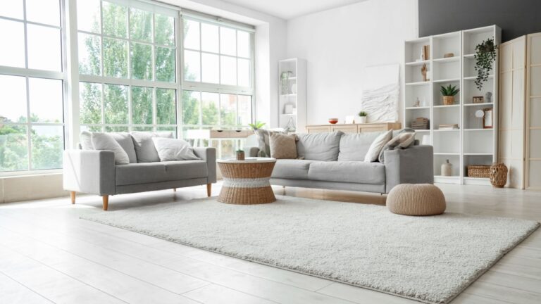 Interior of light living room with sofas, rattan table and soft carpet