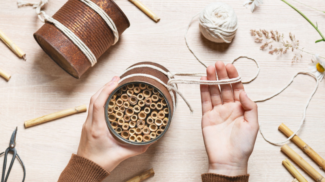 Step 7. Made a hanger out of tread. Create a DIY bug hotel for garden. Kids craft and helping wild animals concept. Top view.