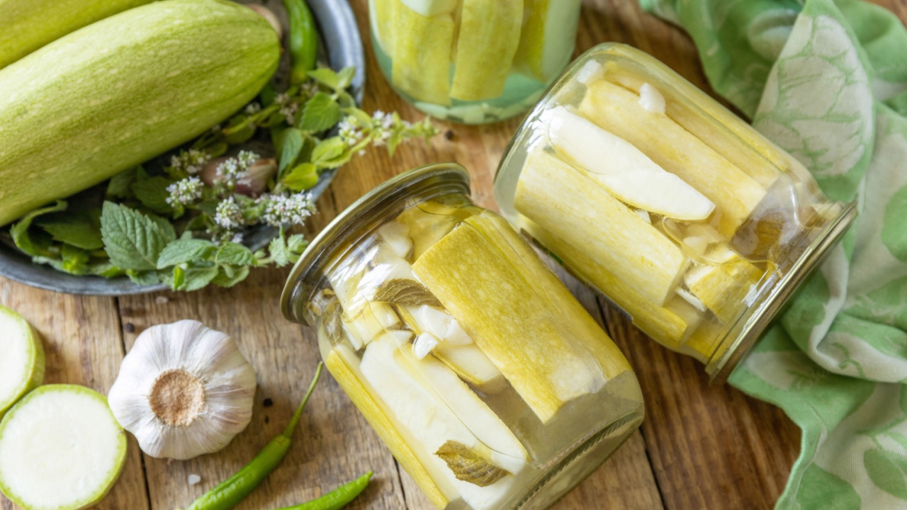 Healthy homemade fermented food. Pickled zucchini with mint preserved canned in glass jar. Home economics, autumn harvest preservation.
