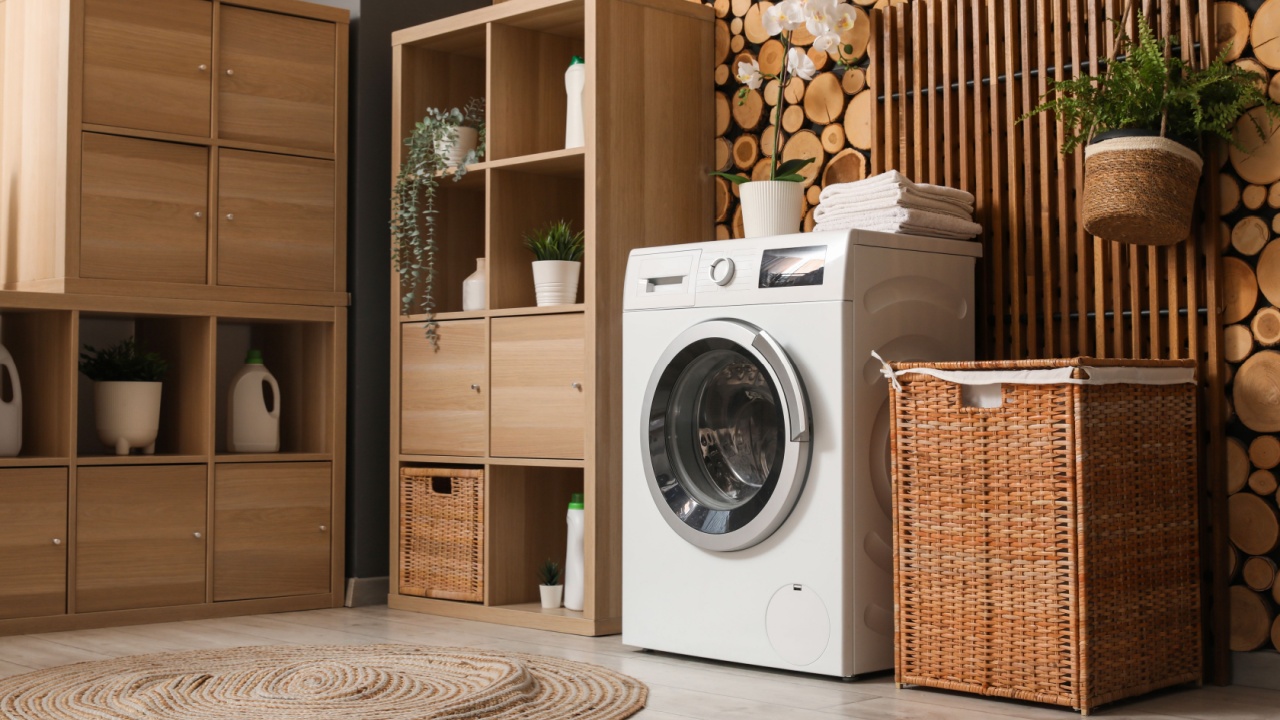 Washing machine, shelving unit, and laundry basket near wooden wall in room