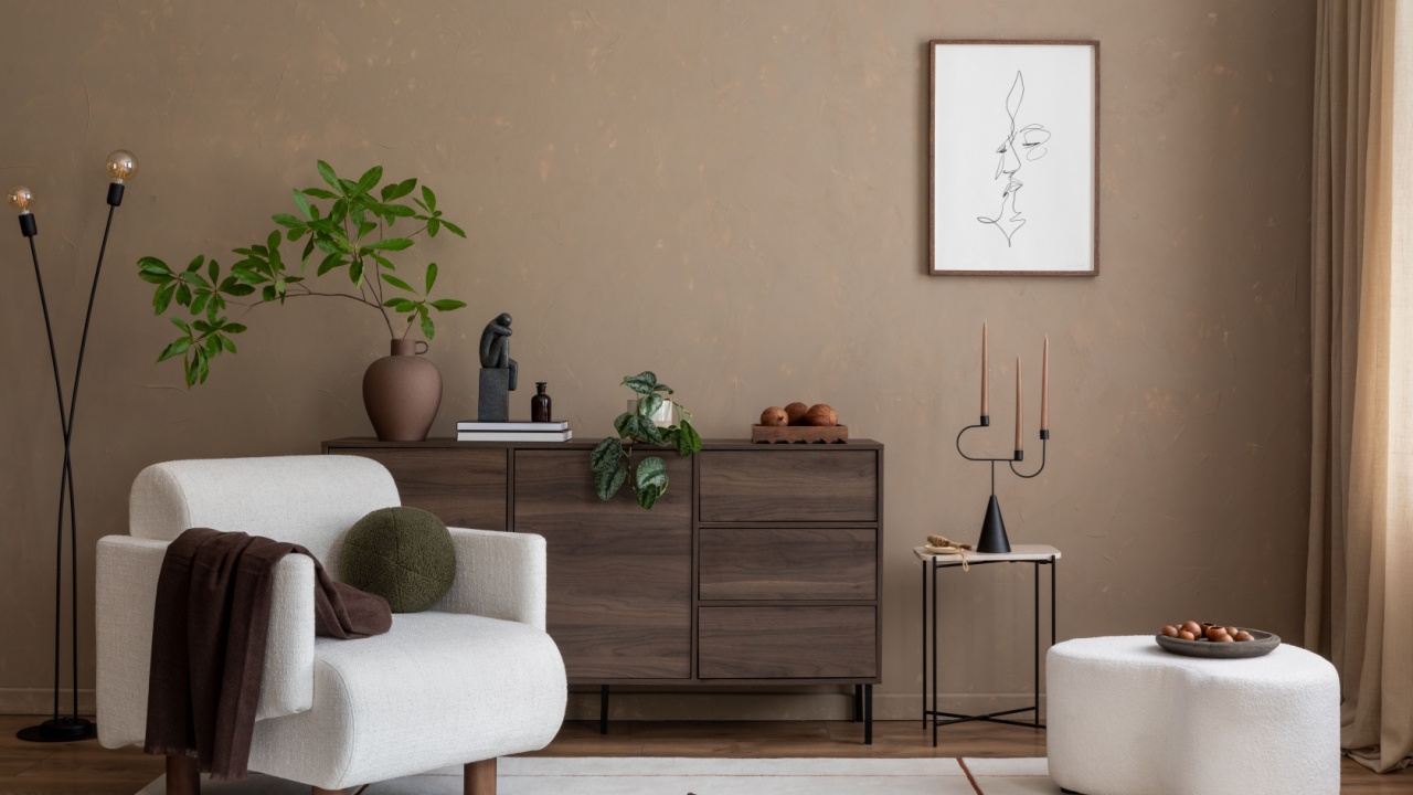Cozy living room featuring a plush armchair, modern wooden sideboard, and a mix of greenery. Warm tones and simple decor create a serene, inviting atmosphere. Template.