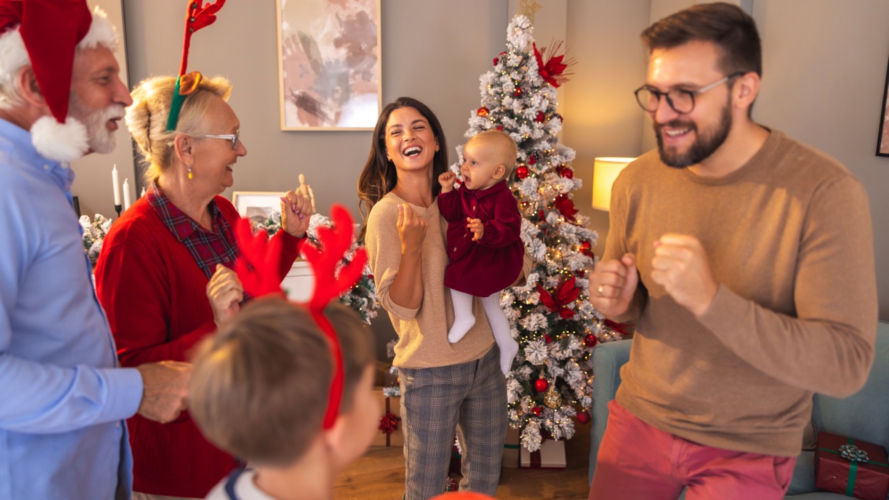 Beautiful happy multi-generation family having New Year's Eve party at home, having fun singing and dancing all together