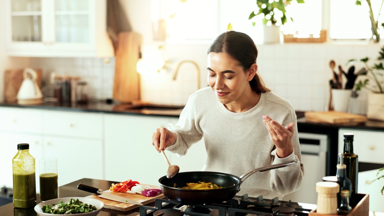 Woman, cooking and pot stove in kitchen for warm food, stew dinner or vegetable hunger. Female person, gas appliance and prepare nutrition eating as soup diet for fresh taste, hobby dish or healthy