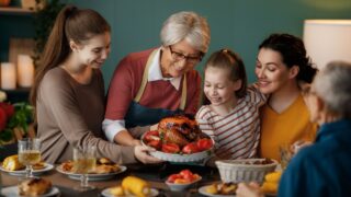 Happy Thanksgiving Day. Autumn feast. Family sitting at the table and celebrating holiday. Grandparents, mother and children. Traditional dinner.