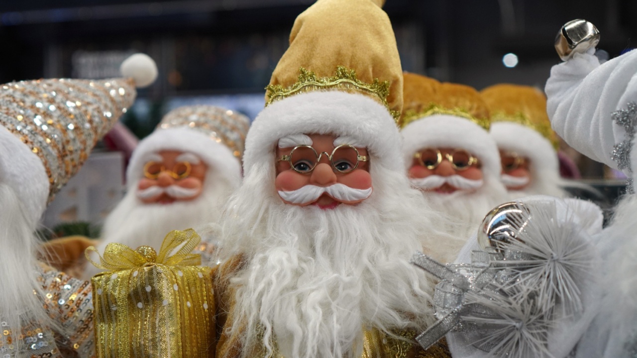 Portrait of toy santa claus in gold suits and glasses in store with new year and christmas gift concept