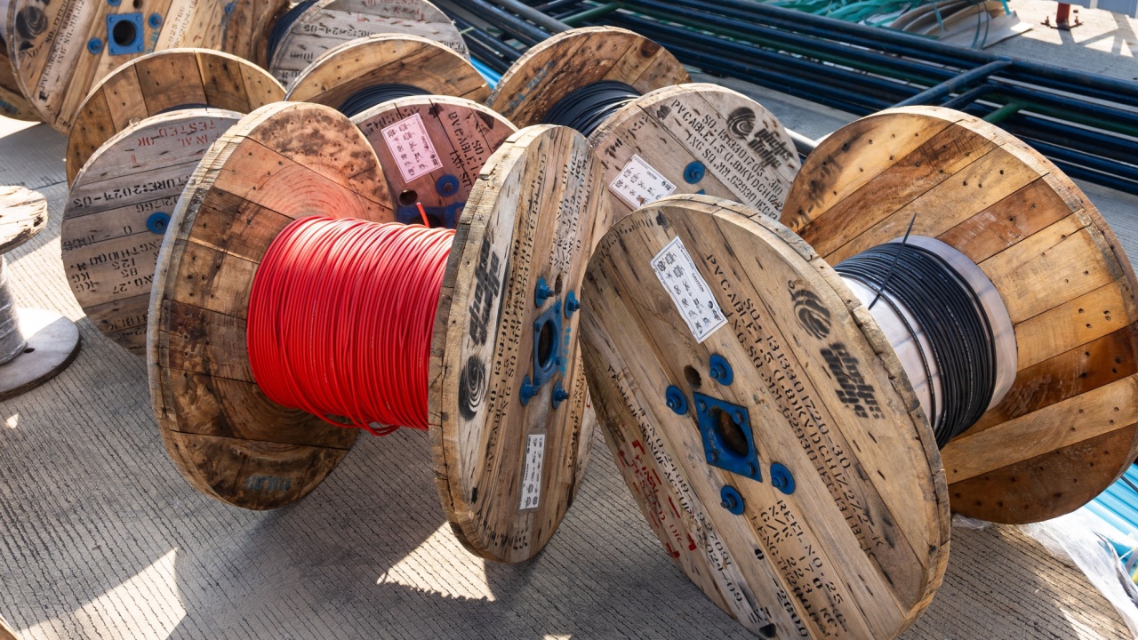 Rayong Province, Thailand - December 23' 2024 : Rolls of electrical wires in wooden rolls, left over from installation.