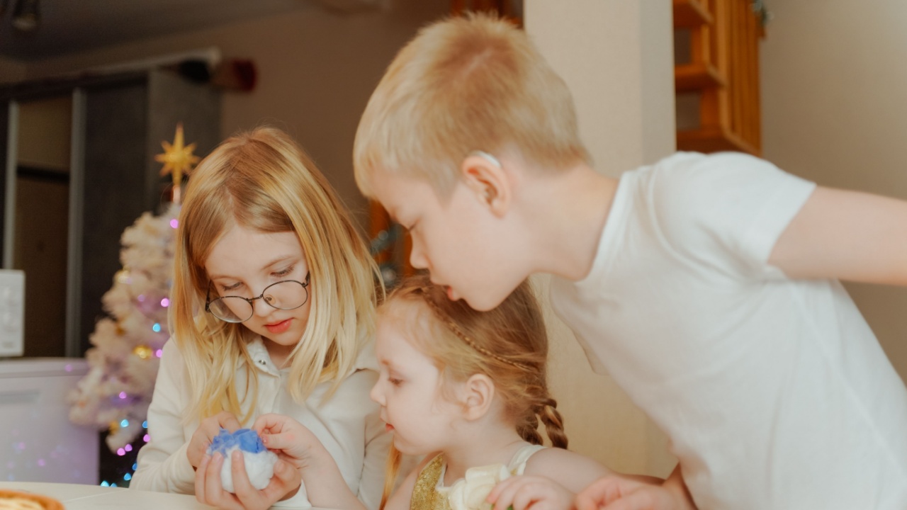 Children prepare for the New Year with their large, cheerful family in a festive atmosphere. They laugh, decorate, and share joyful moments, capturing the warmth and excitement of the holiday season
