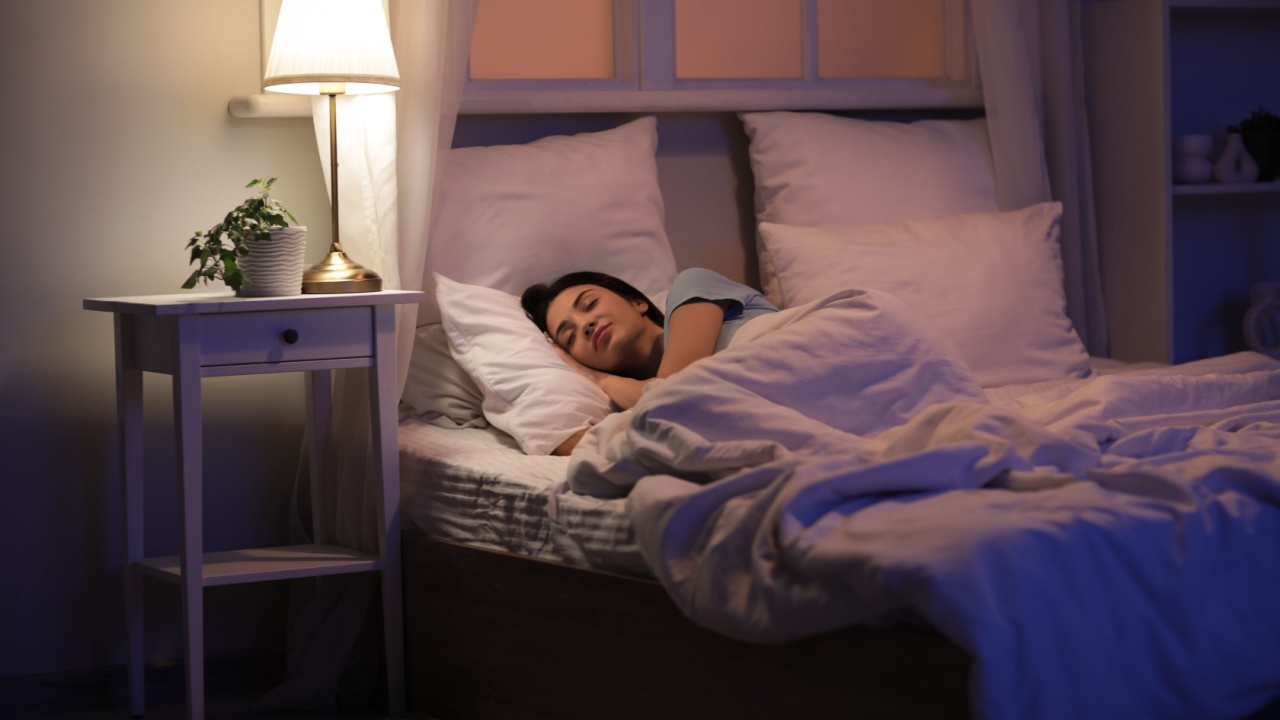 Beautiful young woman sleeping on bed in evening at home