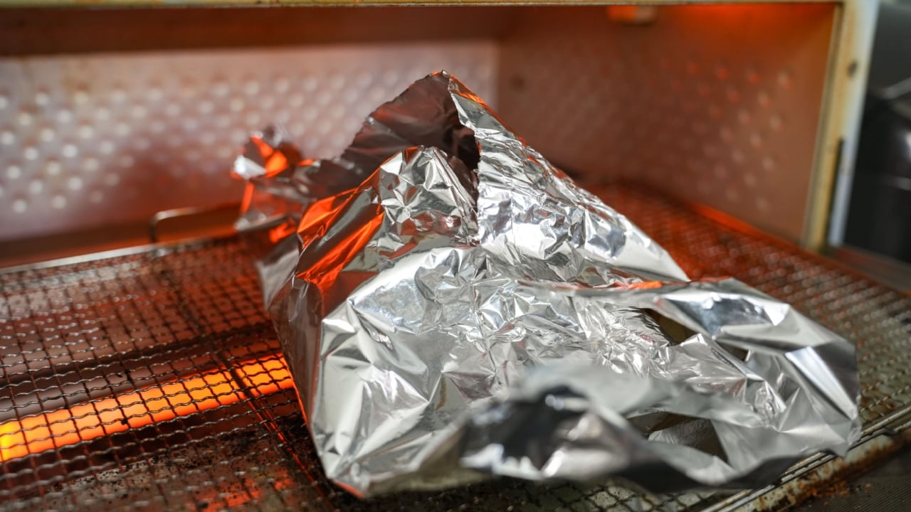 Heating bread wrapped in aluminum foil in a toaster oven