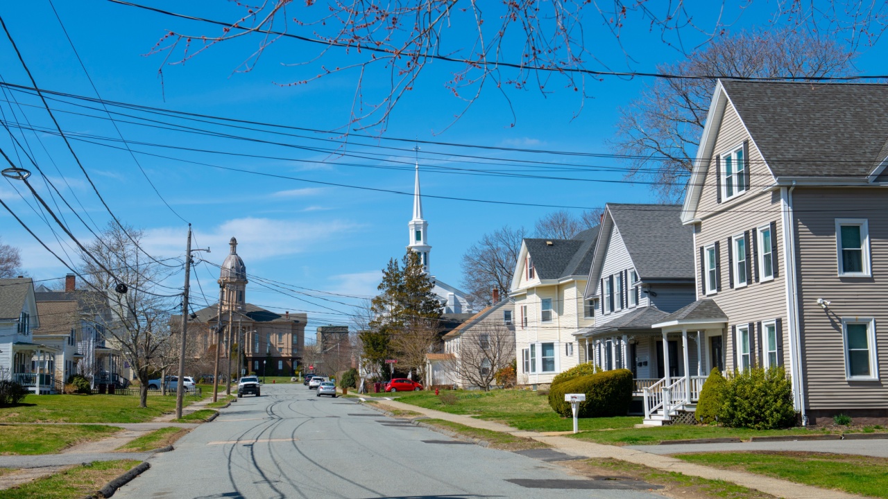 Historic residential house on Webster Street with Town Hall at the back in historic town center of Middleboro, Massachusetts MA, USA.