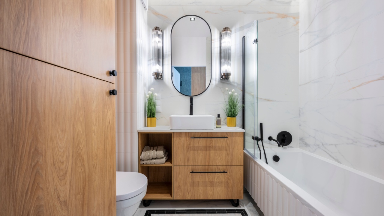 Modern bathroom interior with elegant marble wall tiles and a sleek bathtub.