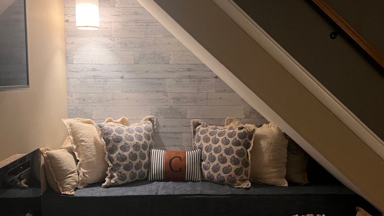Under stairs cozy nook with pillows and light 