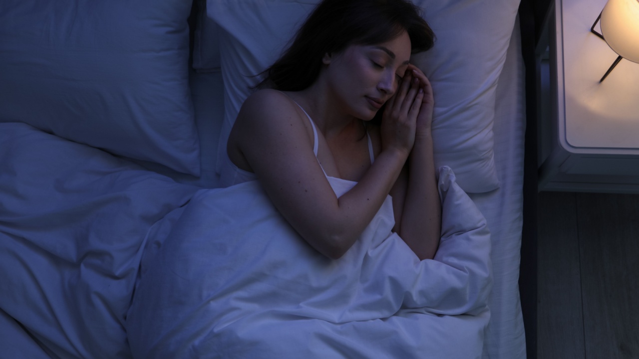 Beautiful woman sleeping in bed at home, top view