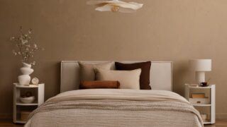 Minimalist bedroom with pendant light, white nightstands and neutral bedding.