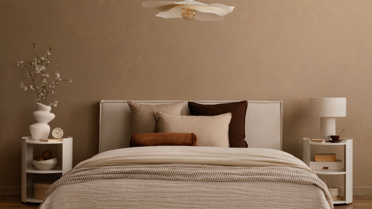 Minimalist bedroom with pendant light, white nightstands and neutral bedding.