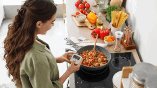 woman in the kitchen fried rice setting a timer