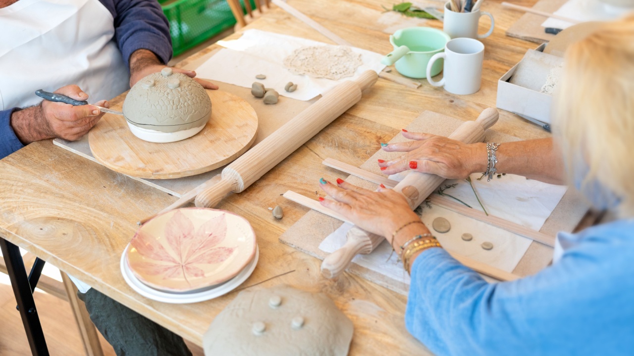 People hands working with clay during a ceramics workshop. Creating handmade pottery, developing new skills and enjoying a hobby