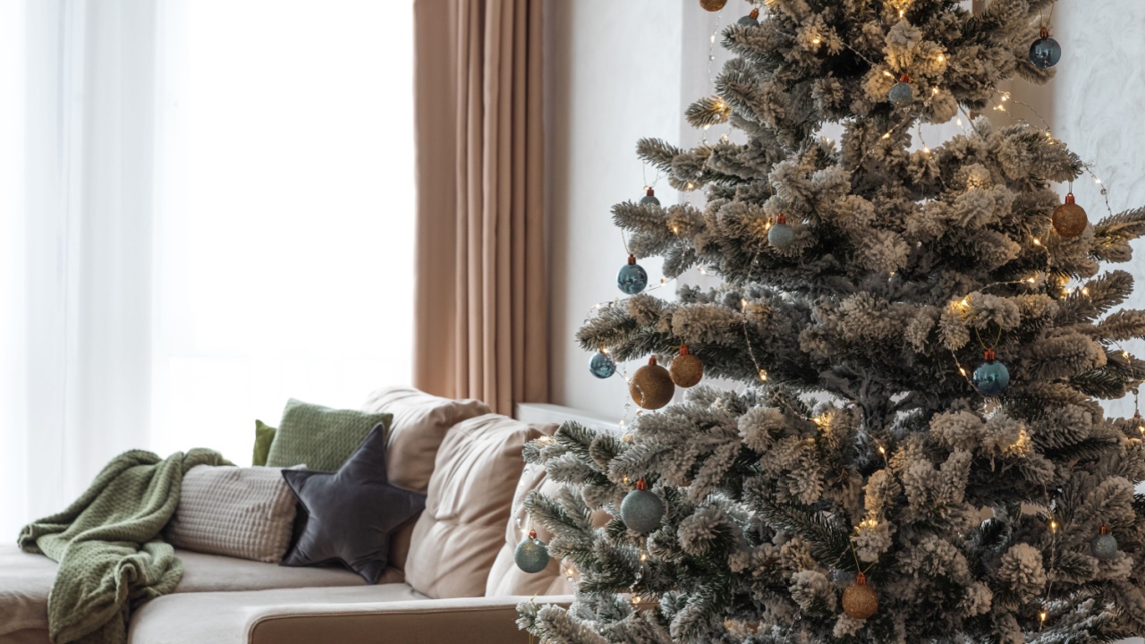 Festive Living Room with Snow-Flocked Christmas Tree and Cozy Decor