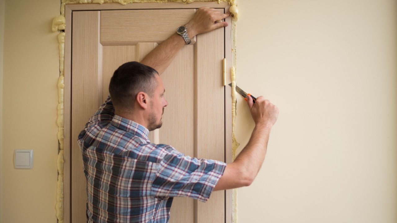 Master knife cuts off excess foam. Installation of doors using polyurethane foam mounting. Сutting foam after mounting a door. Polyurethane foam. Saves energy.