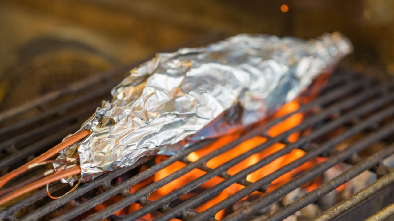 Grilling Thai lobster in tin foil at local market