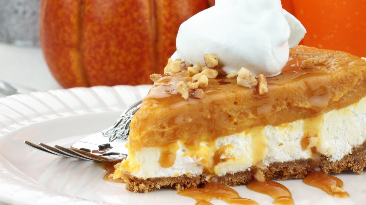 Slice of Double Layer No Bake Pumpkin Pie made with pumpkin, vanilla pudding,cream cheese, and whipped cream.