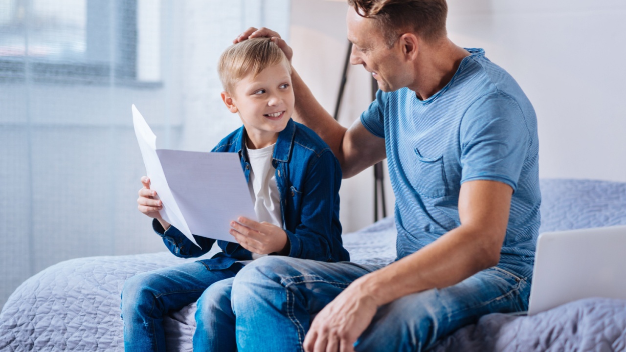 Loving father patting his son on the head