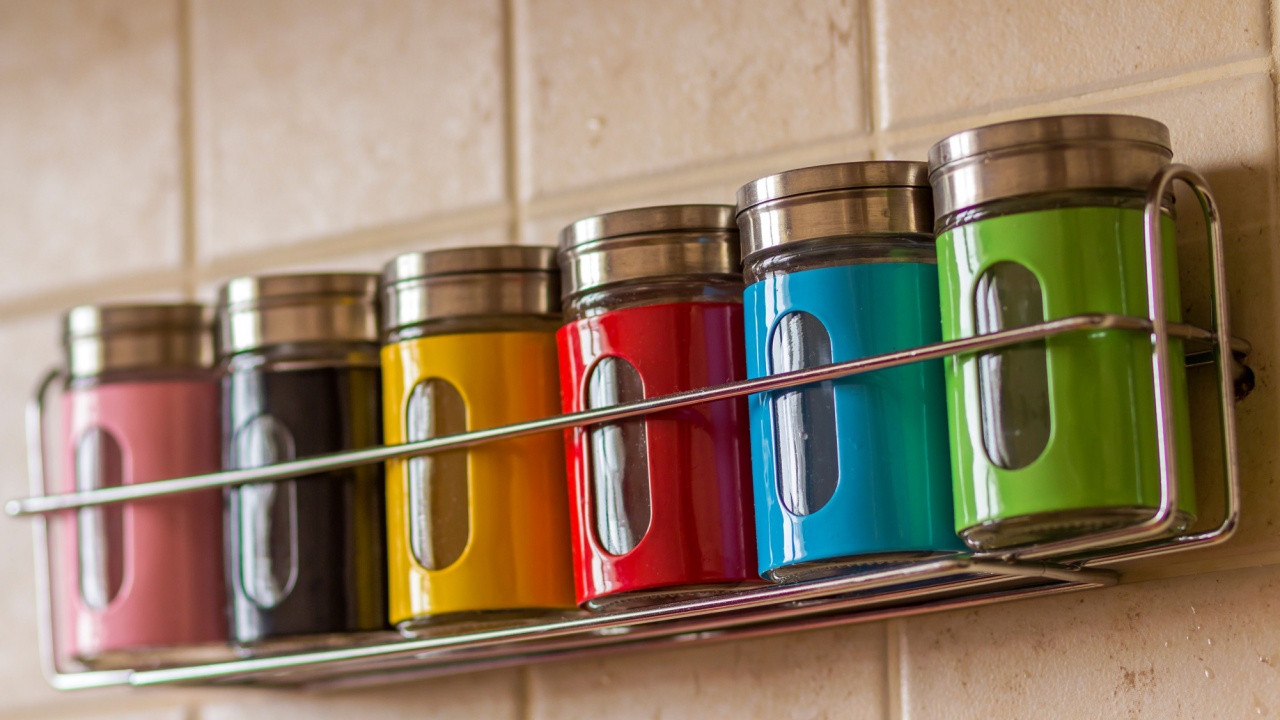Colorful spice salt and pepper containers in kitchen