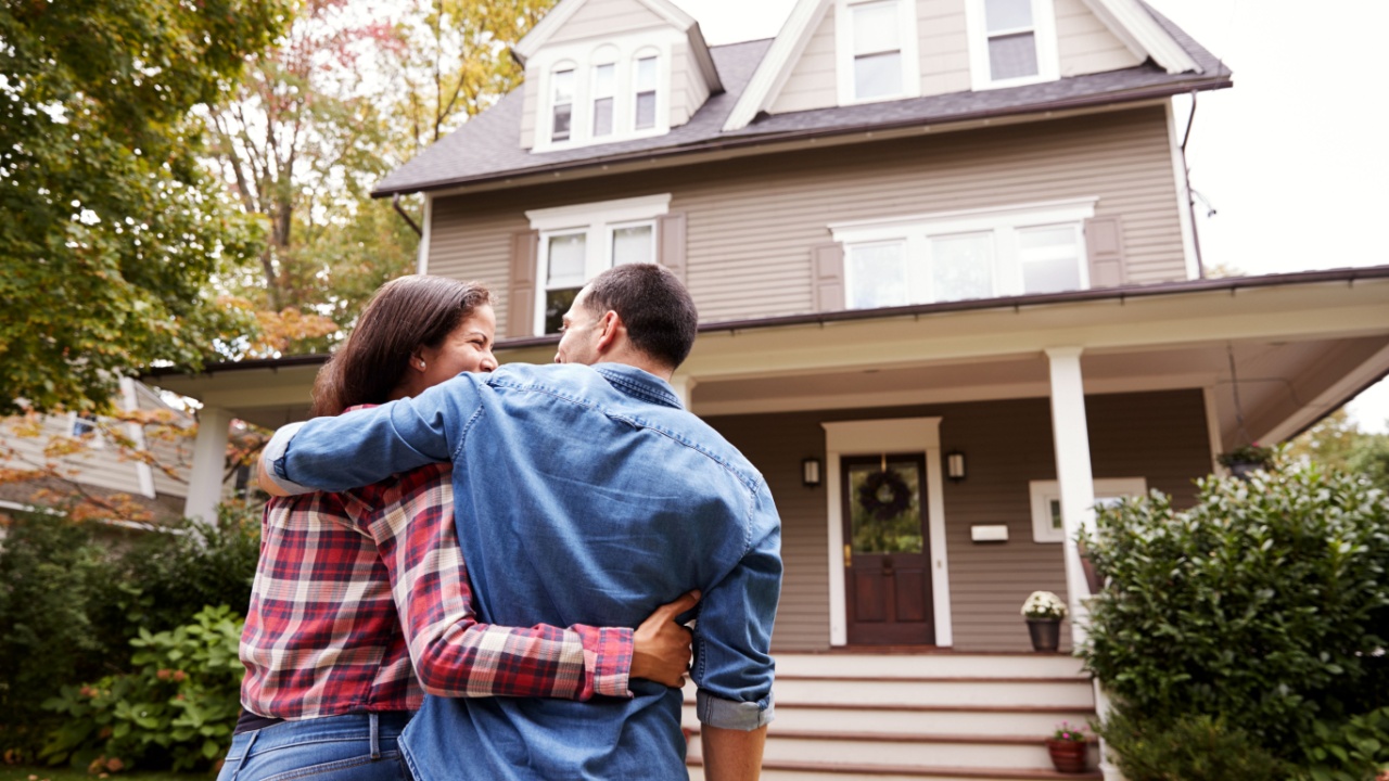 Rear View Of Loving Couple Walking Towards House