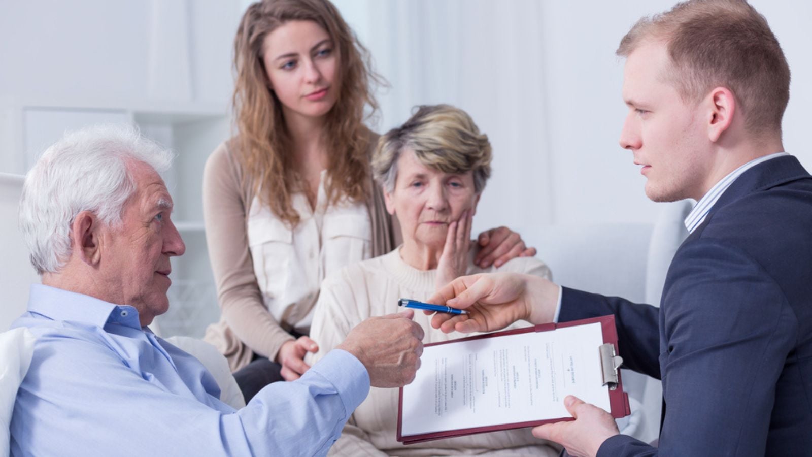 man signing a will while sick at the hospital stressed woman planning