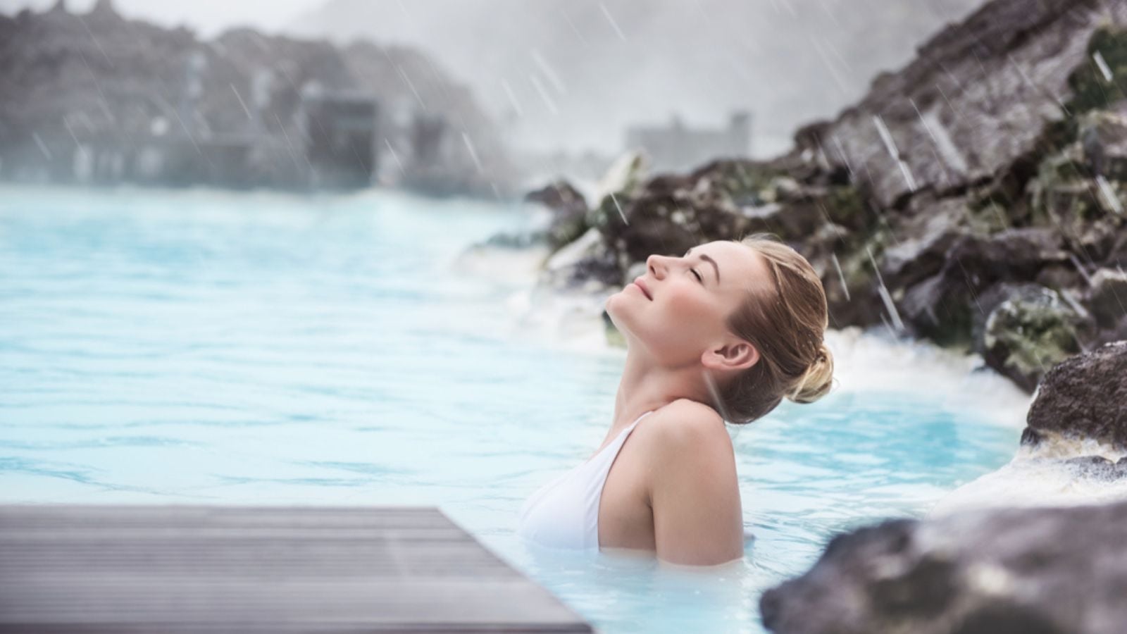Woman enjoying natural spa, Blue Lagoon is a geothermal spa in southwestern Iceland