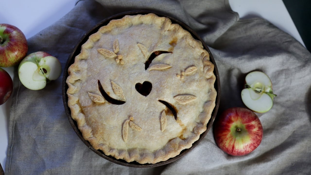 a apple pie surrounded by apples
