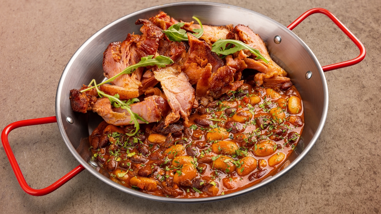 a skillet with beans and ham hocks