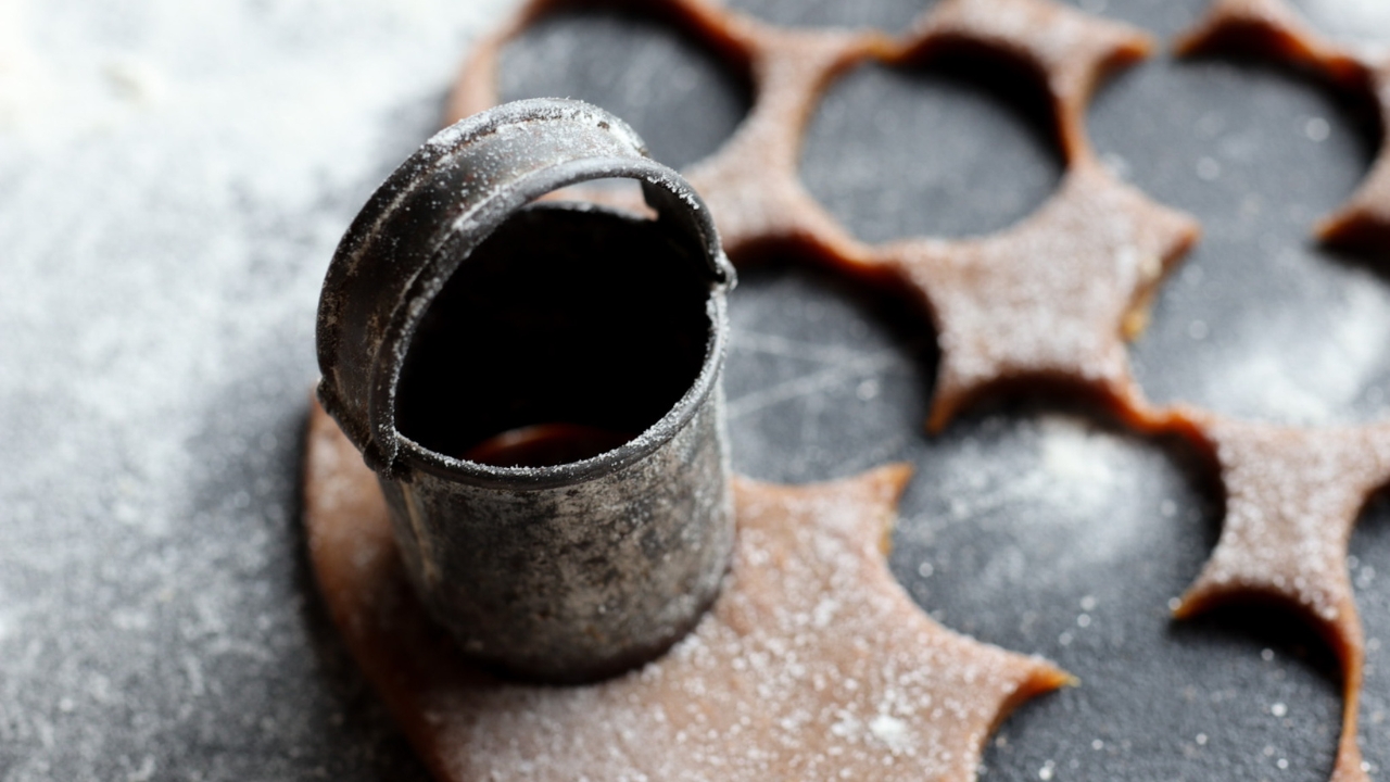 an antique cookie cutter with cookie dough