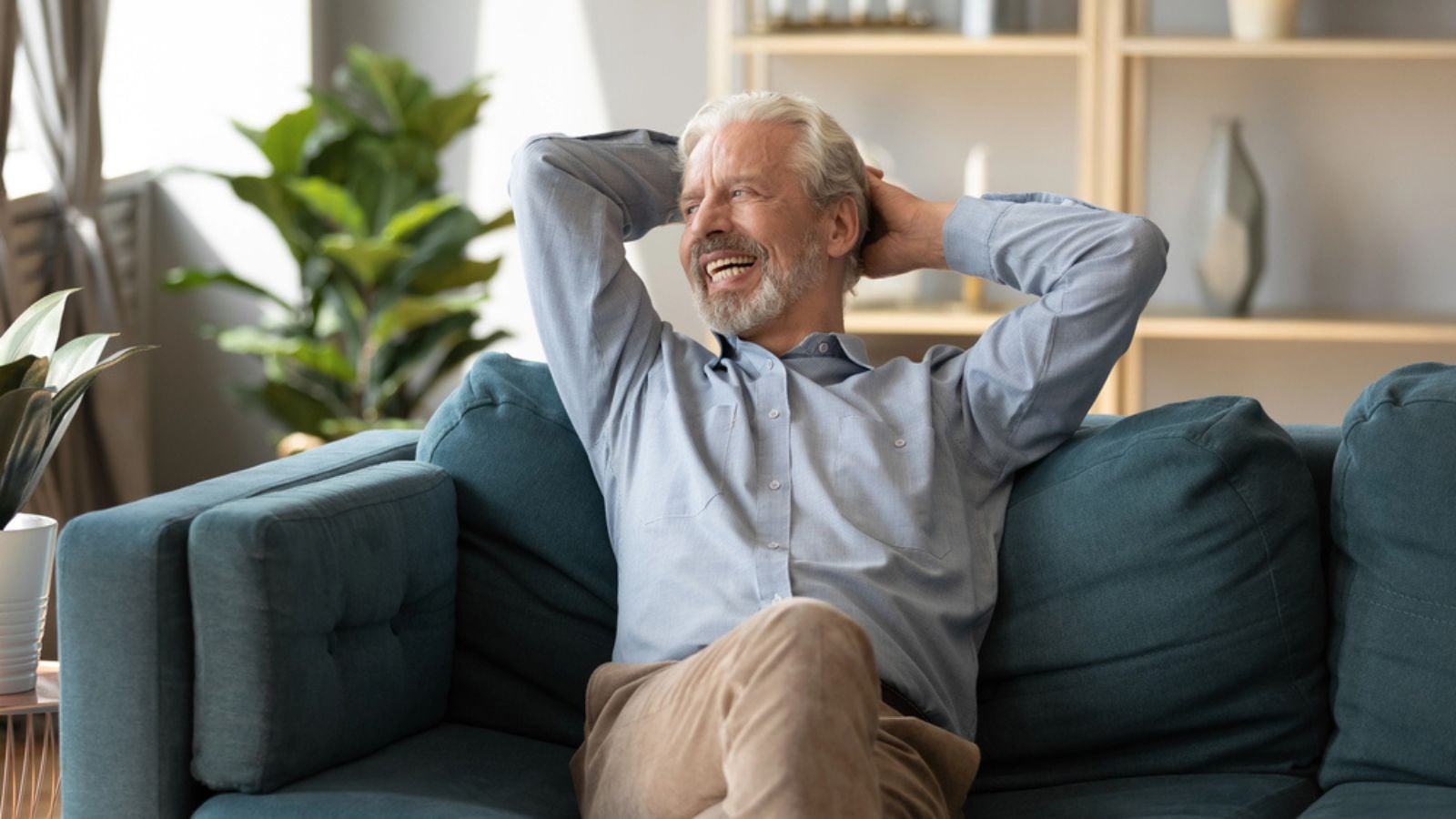 happy peaceful man retired old sitting on couch