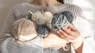 an armful of yarn balls for knitting