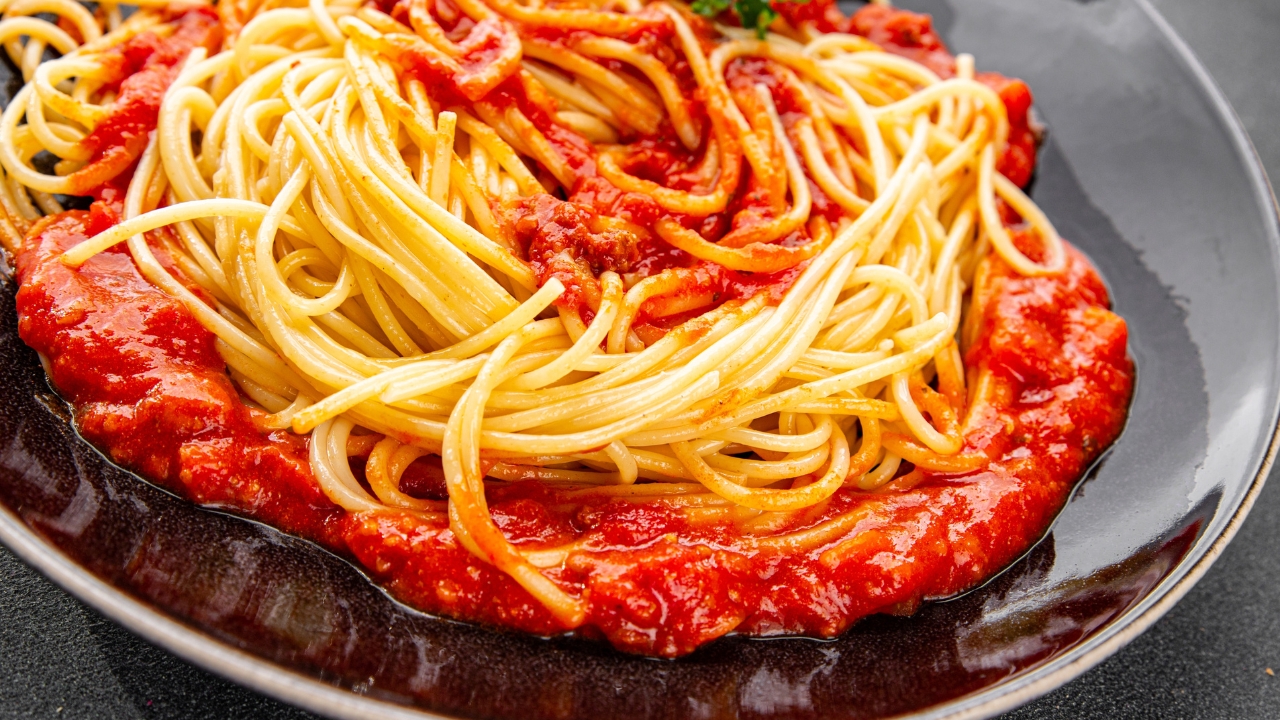 a large dish of pasta with tomato sauce
