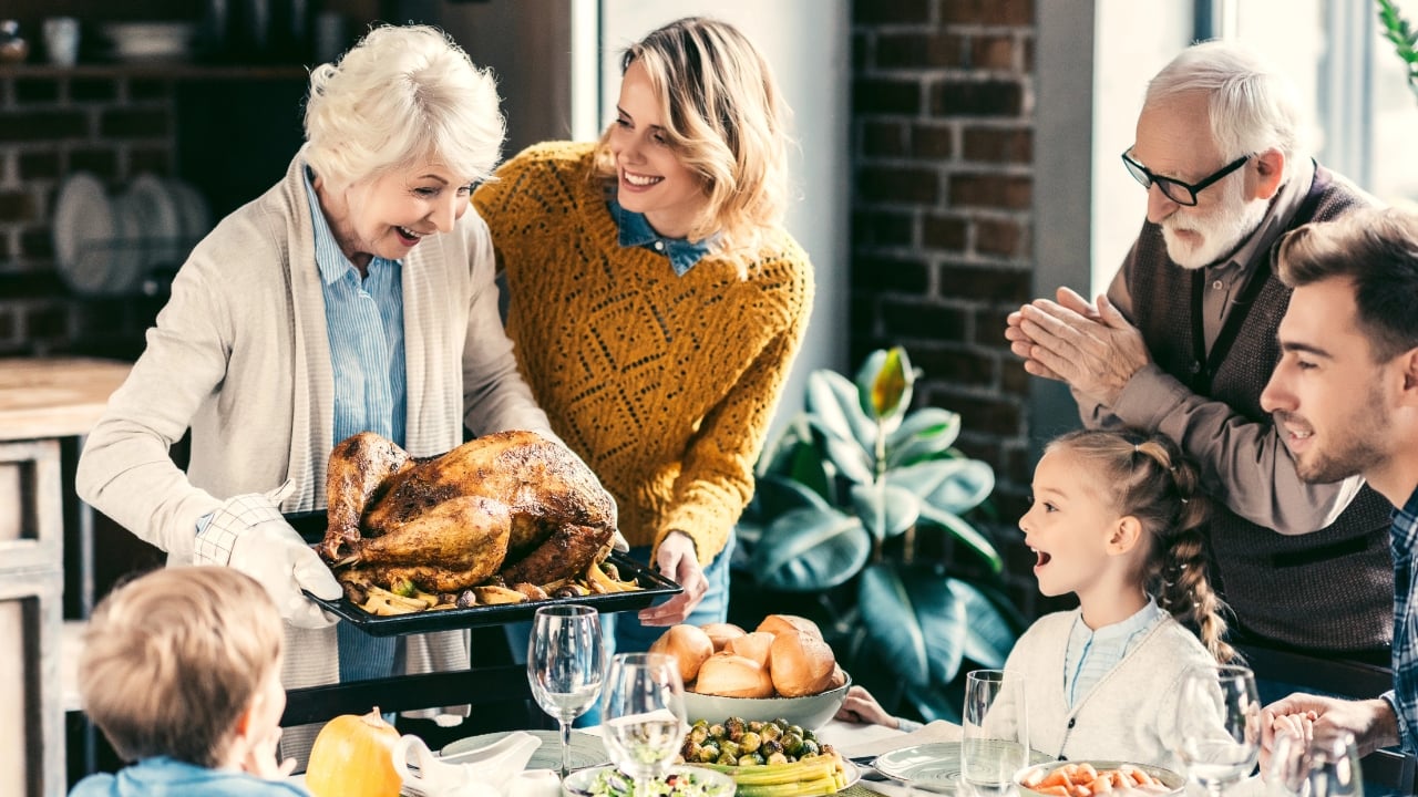 A family gathers around a Thanksgiving table