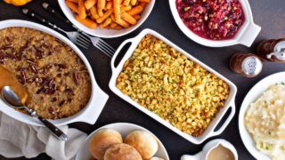 a table full of Thanksgiving side dishes