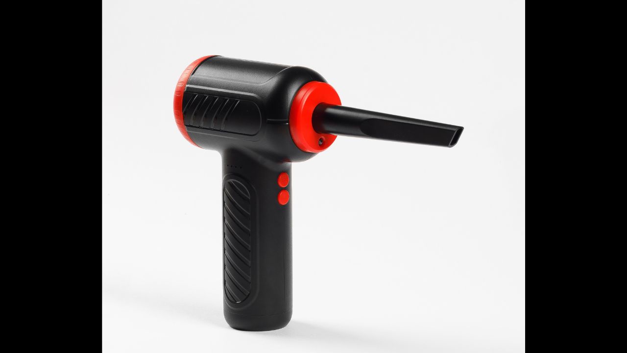 A black and red air duster tool is currently resting on a clean white surface, perfect for a variety of cleaning tasks and uses