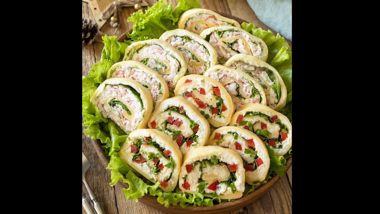 Creative appetizers christmas. Cheese roll with cream cheese, sweet pepper and greens.