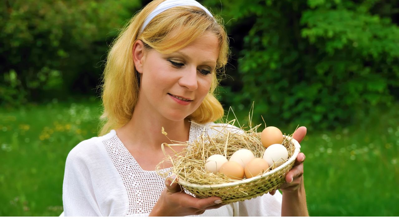Happy young woman holding fresh eggs