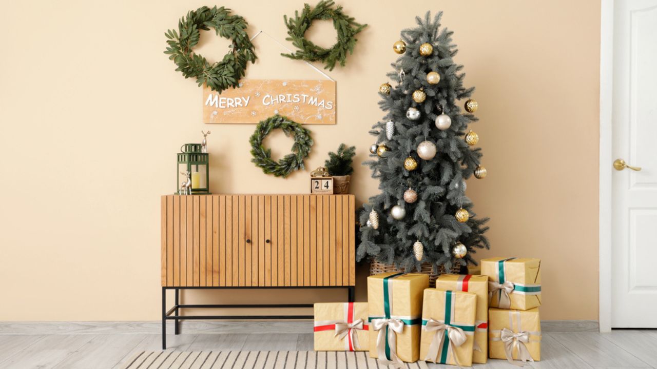 Interior of living room with Christmas trees, wreaths and drawers