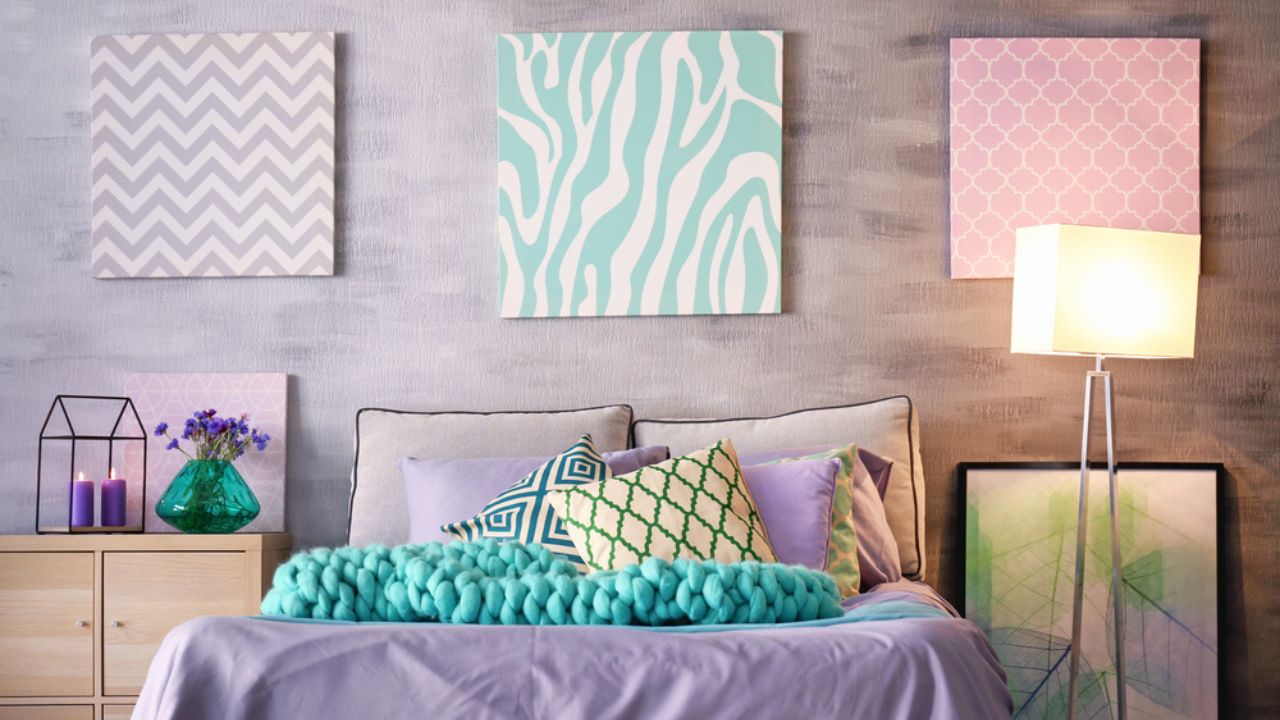 Lilac accent in modern interior. Comfortable bed with pillows and plaid in room